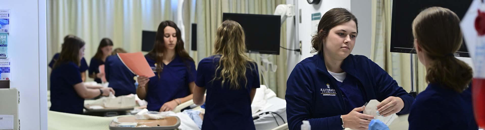 护理 students practice their skills in the nursing SIM lab.